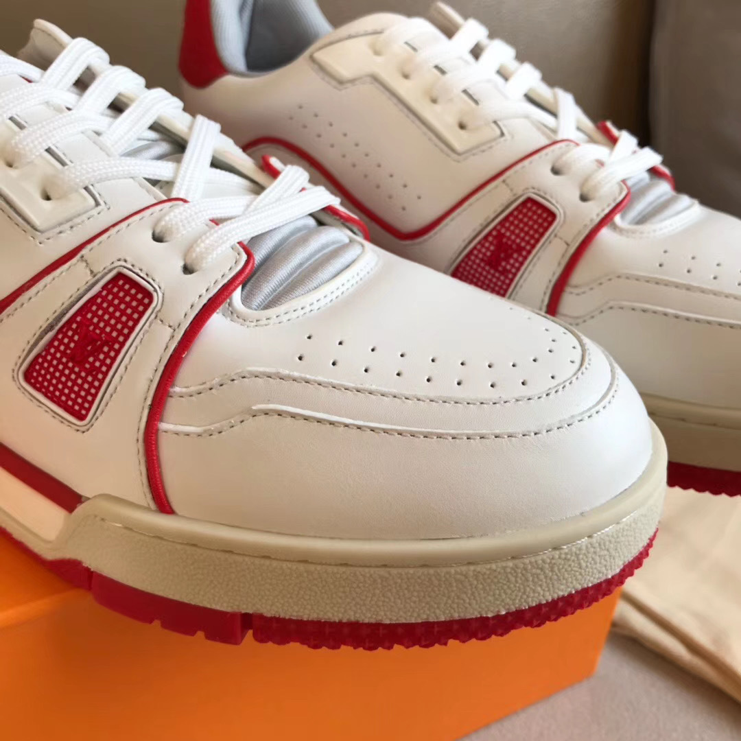 LV Trainer Sneaker in white and red is designed with grained calf leather and features sporty color accents inspired by vintage basketball shoes