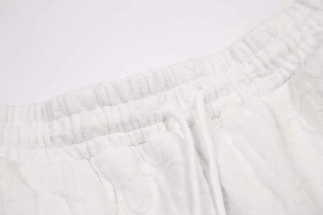 Dolce & Gabbana logo-embroidered Bermuda shorts featuring a drawstring waist and side zip pockets.