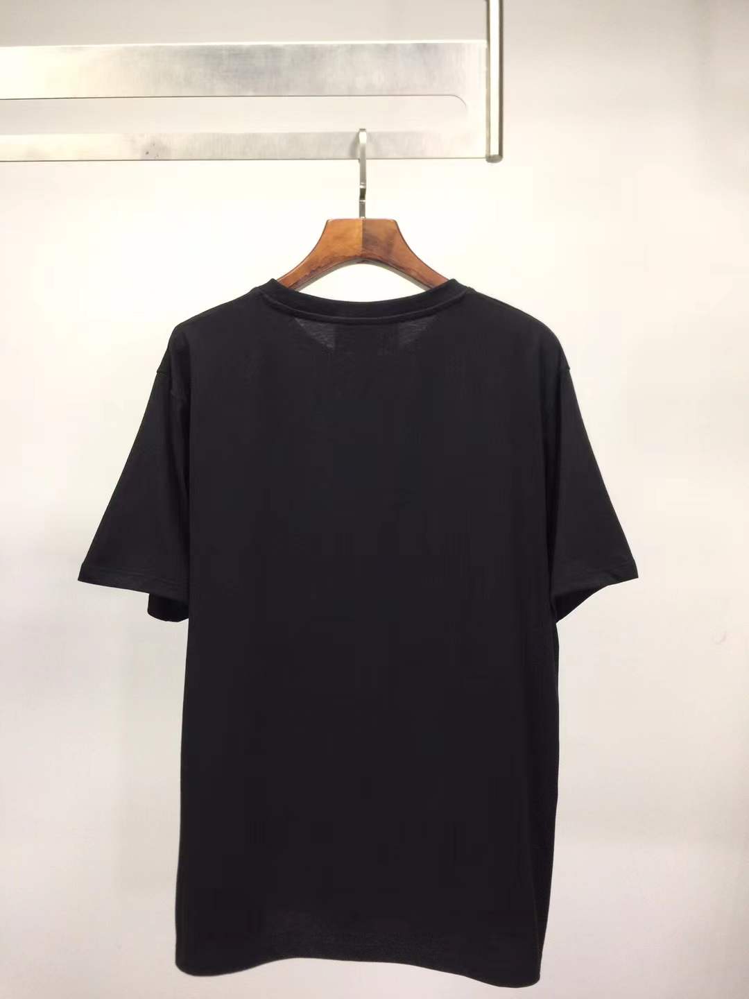 Gucci black t-shirt featuring a printed graphic of shoes with hanging shoelaces