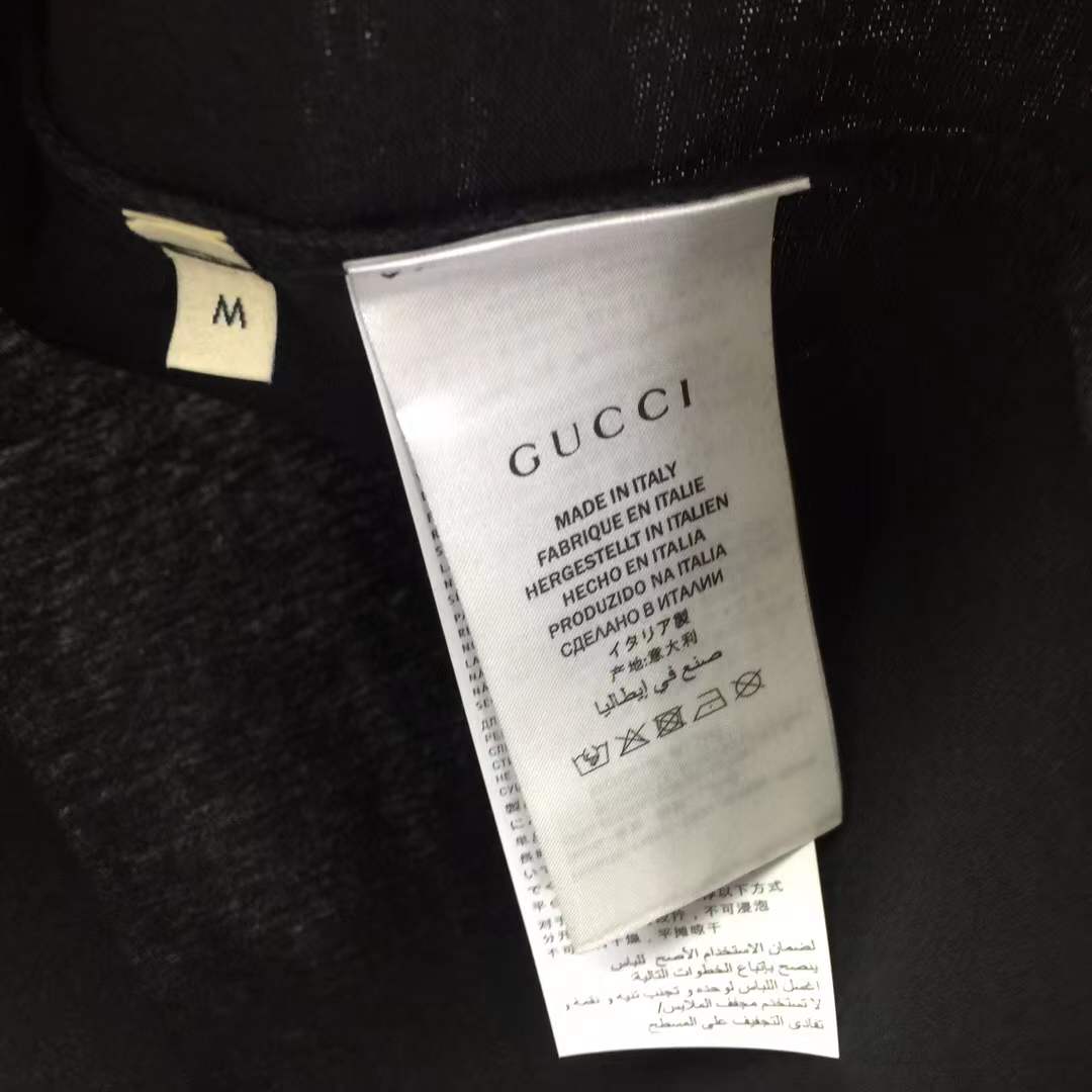Gucci black t-shirt featuring a printed graphic of shoes with hanging shoelaces