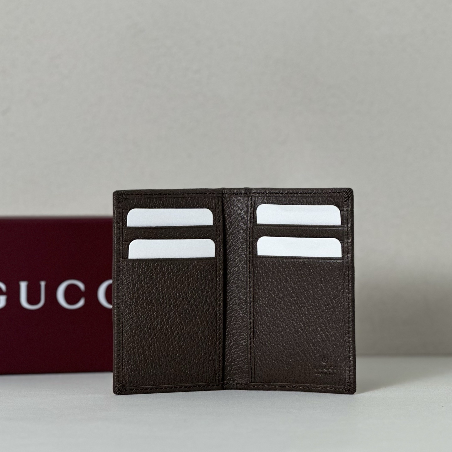 Gucci wallet featuring a camouflage design over the iconic GG Supreme canvas pattern