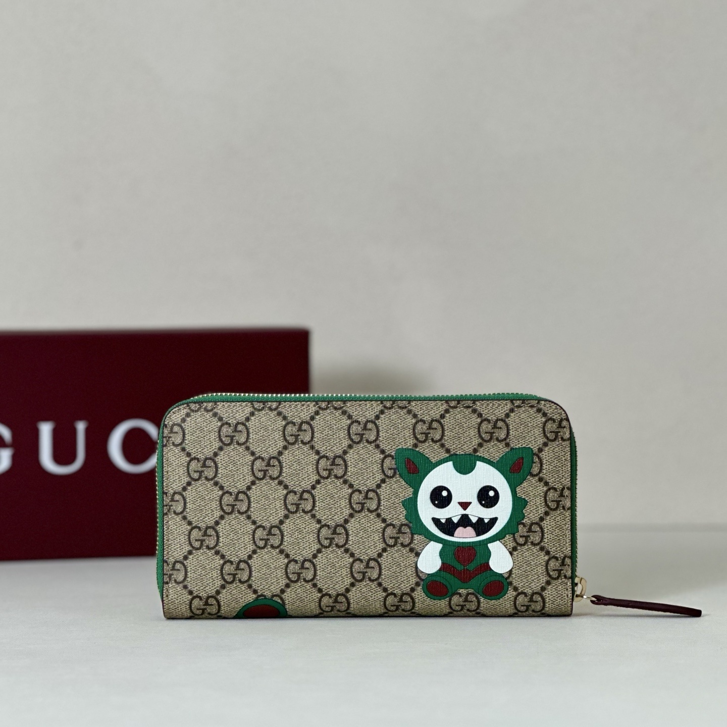 Gucci GG Supreme canvas zip-around wallet featuring a whimsical creature print