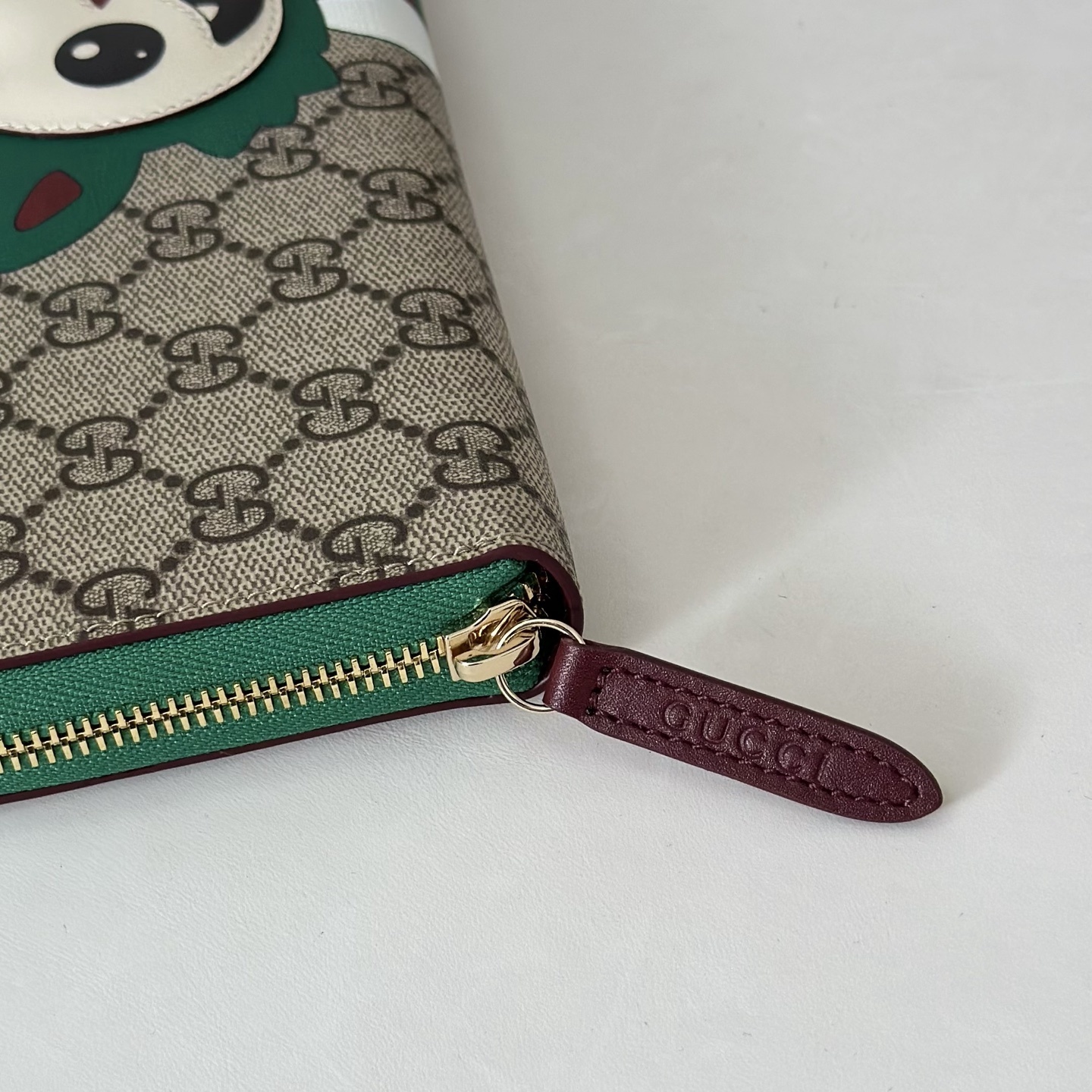 Gucci GG Supreme canvas zip-around wallet featuring a whimsical creature print