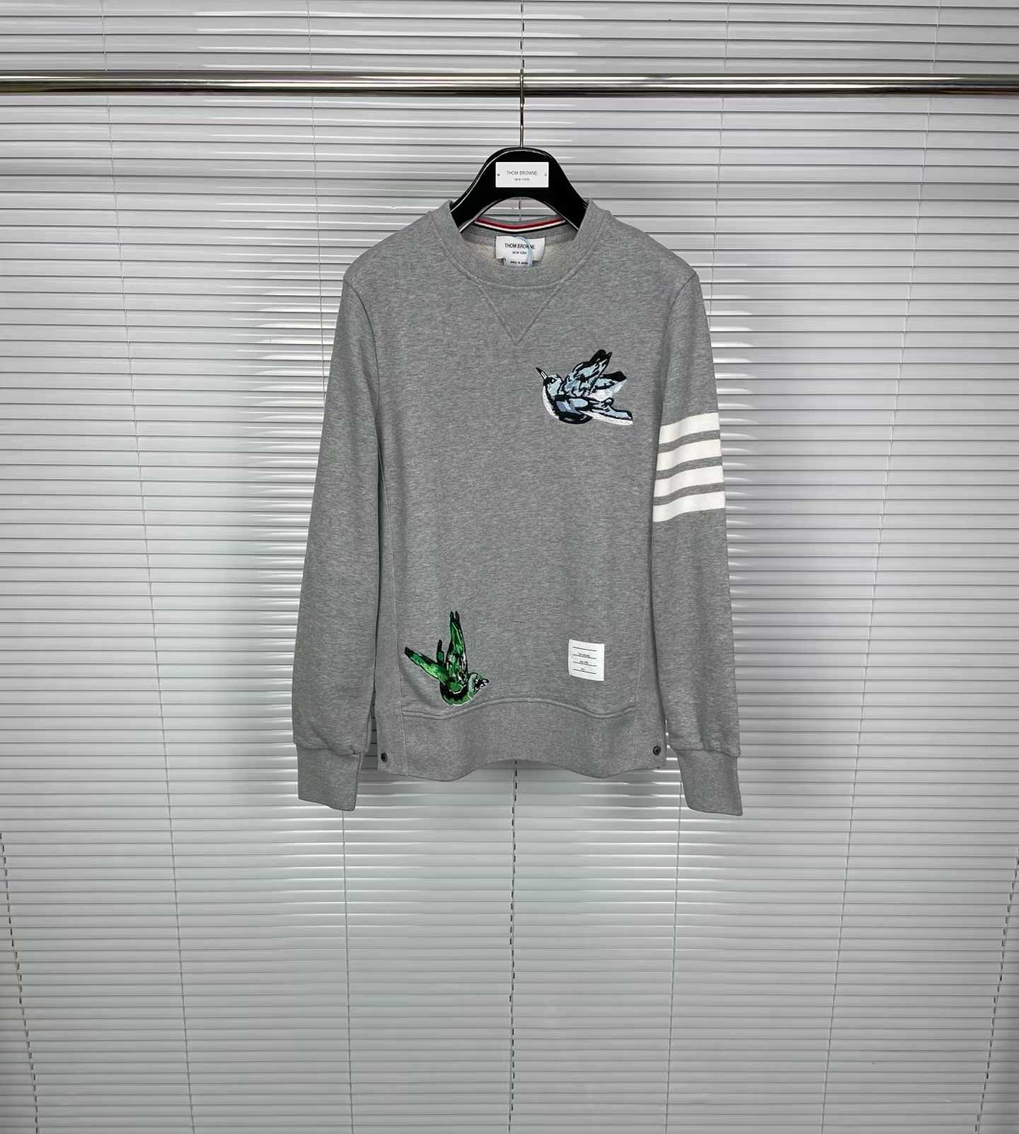 Thom Browne grey cotton sweatshirt featuring bird embroideries and the brand's signature four-bar stripes