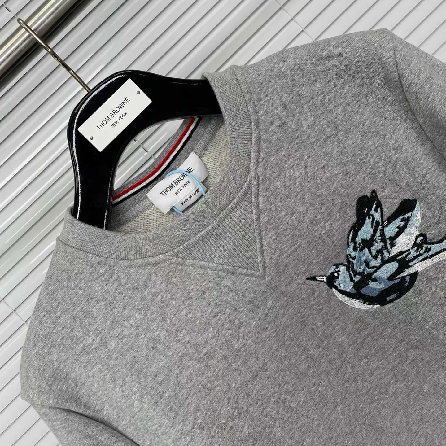 Thom Browne grey cotton sweatshirt featuring bird embroideries and the brand's signature four-bar stripes