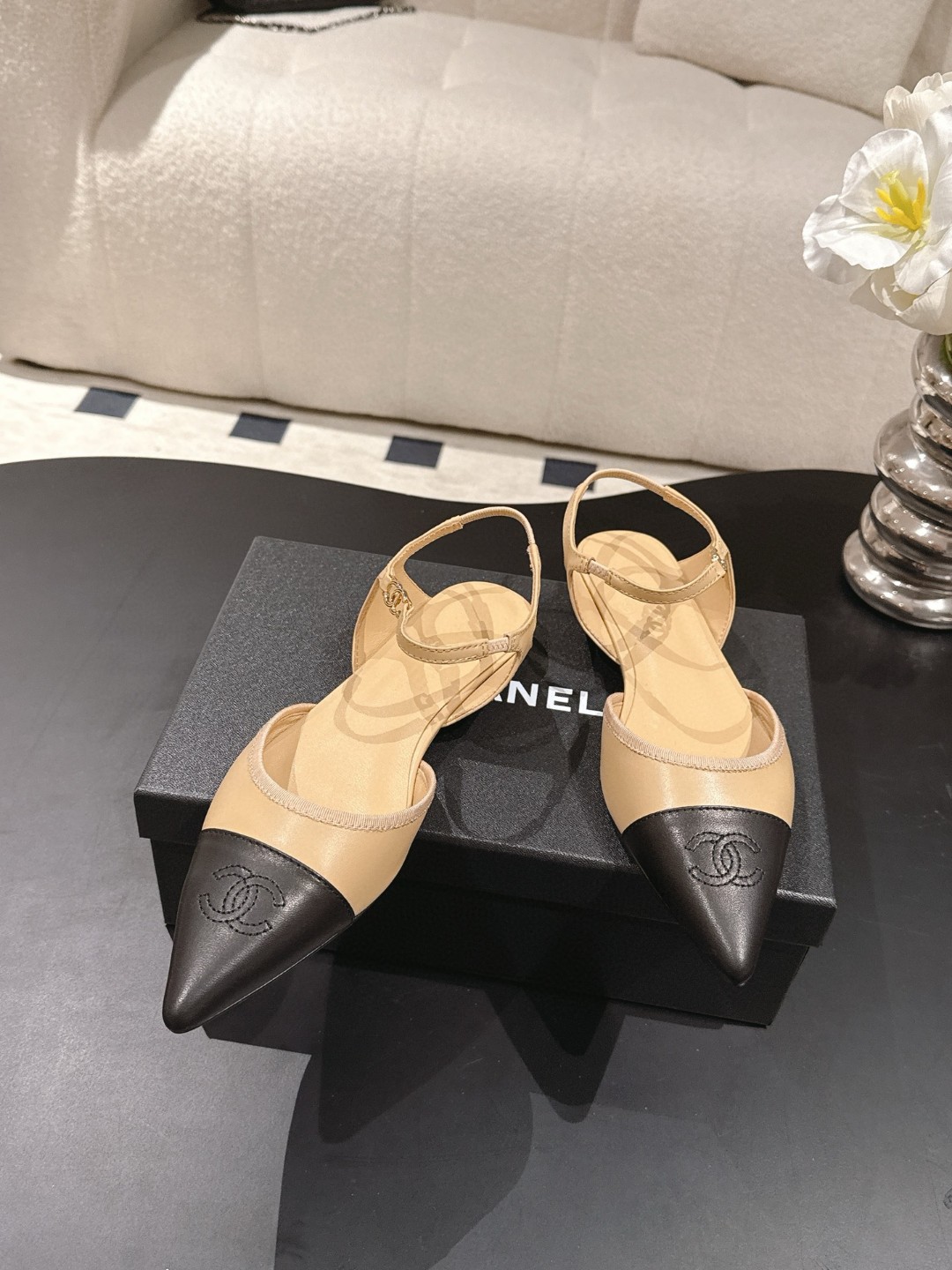 Chanel Beige and Black Leather Cap Toe D'Orsay Flats feature ankle straps and a pointed design.