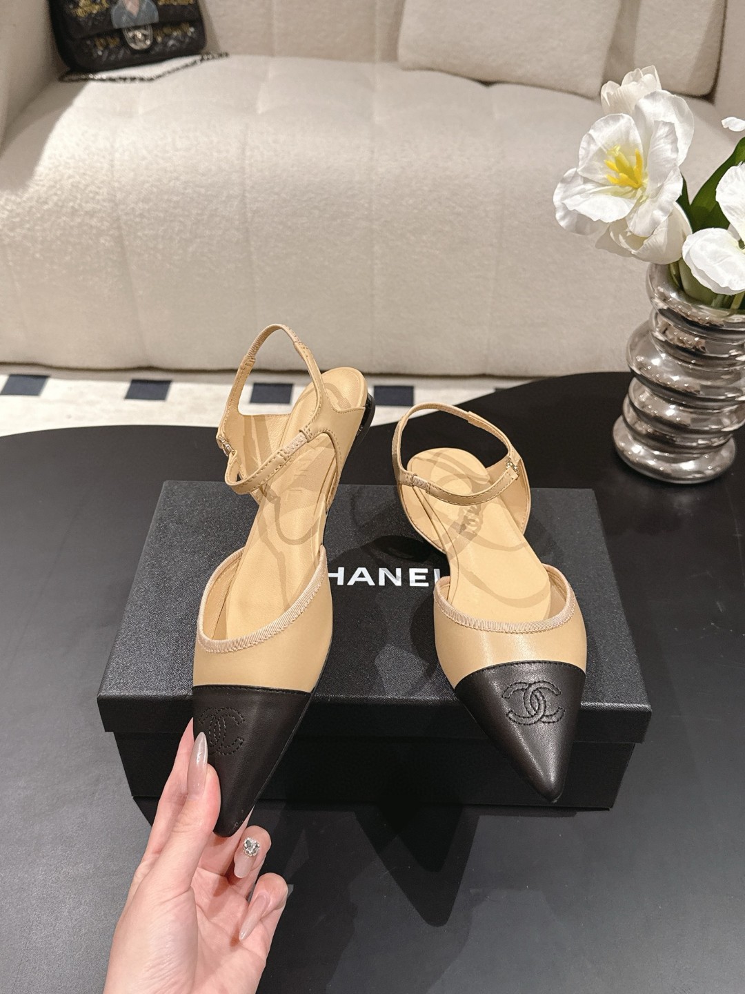 Chanel Beige and Black Leather Cap Toe D'Orsay Flats feature ankle straps and a pointed design.