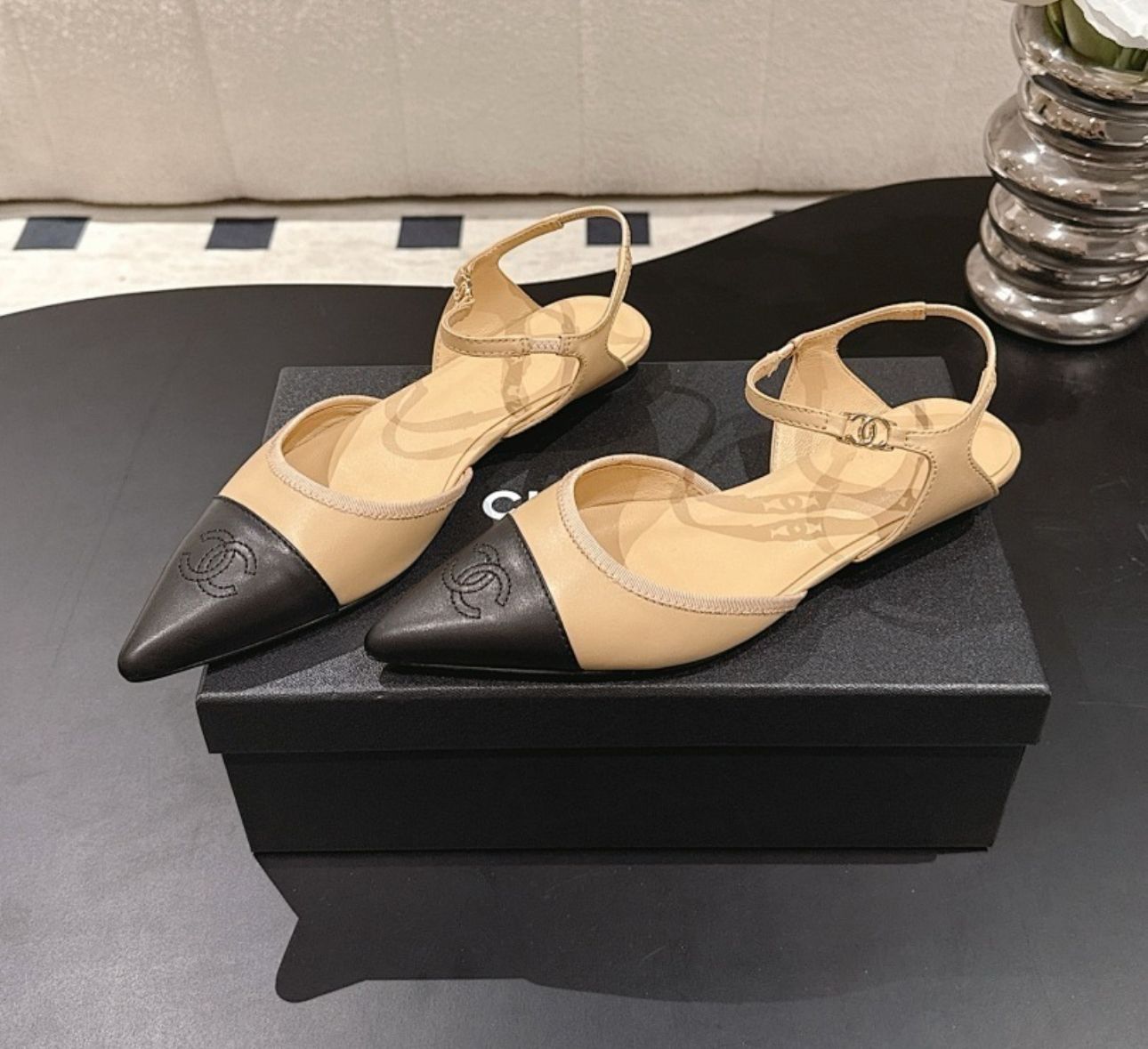 Chanel Beige and Black Leather Cap Toe D'Orsay Flats feature ankle straps and a pointed design.