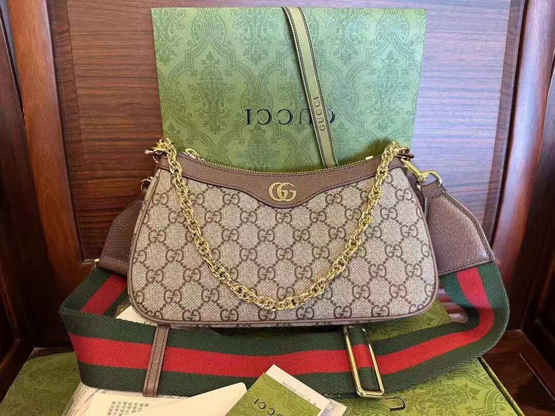 Gucci Ophidia GG Small Handbag in beige and ebony Supreme canvas features leather trim, the iconic green and red Web stripe, and a chain strap