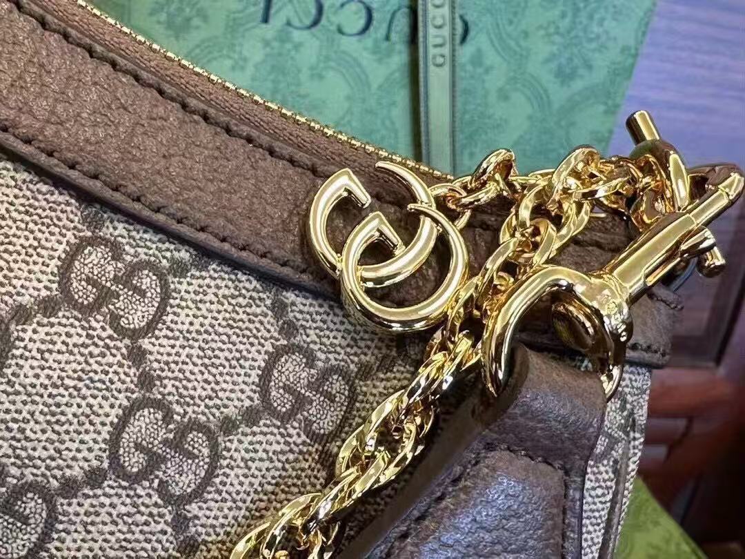 Gucci Ophidia GG Small Handbag in beige and ebony Supreme canvas features leather trim, the iconic green and red Web stripe, and a chain strap