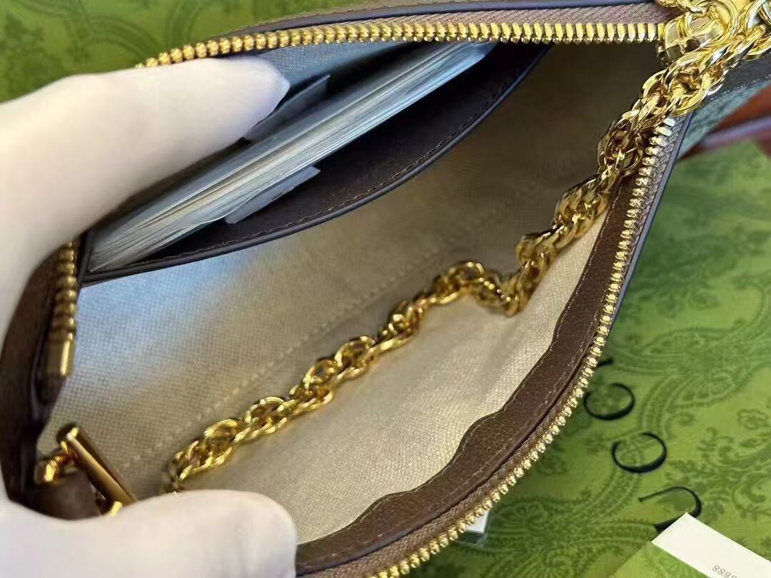 Gucci Ophidia GG Small Handbag in beige and ebony Supreme canvas features leather trim, the iconic green and red Web stripe, and a chain strap