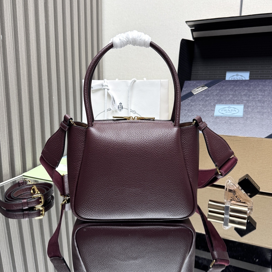 Prada Small Leather Tote Bag, featuring two rolled top handles and an adjustable detachable shoulder strap