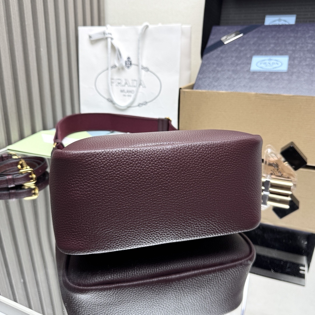 Prada Small Leather Tote Bag, featuring two rolled top handles and an adjustable detachable shoulder strap