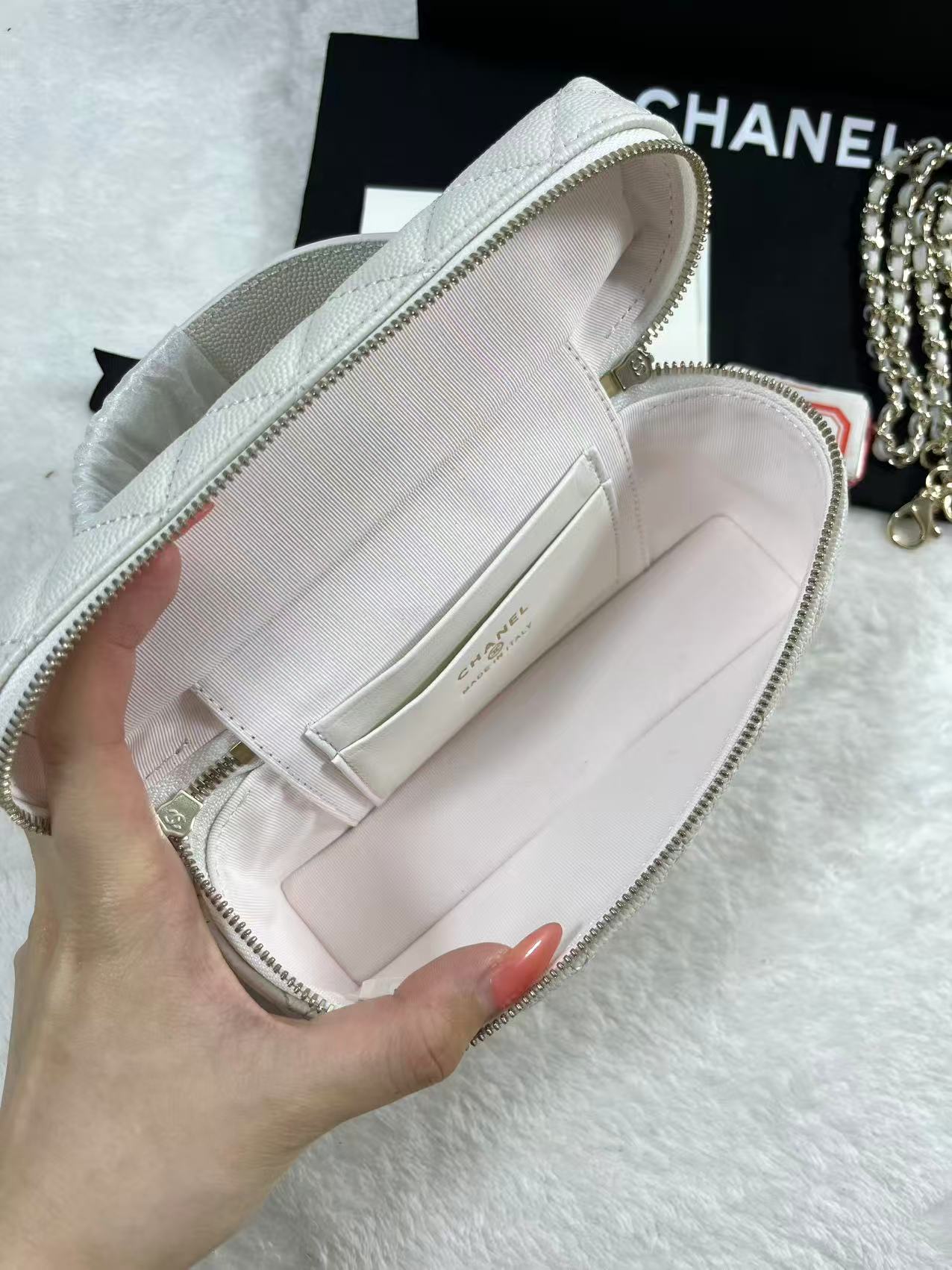 Chanel vanity case likely crafted from white quilted caviar leather featuring gold-tone hardware