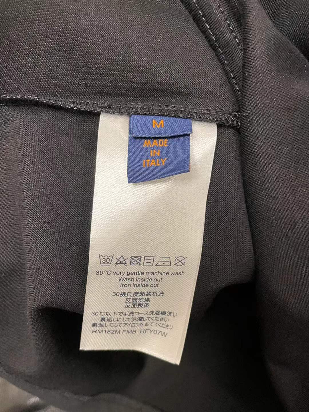 LV t-shirt features a distinctive green and black checkered graphic print resembling one of the brand's iconic handbags