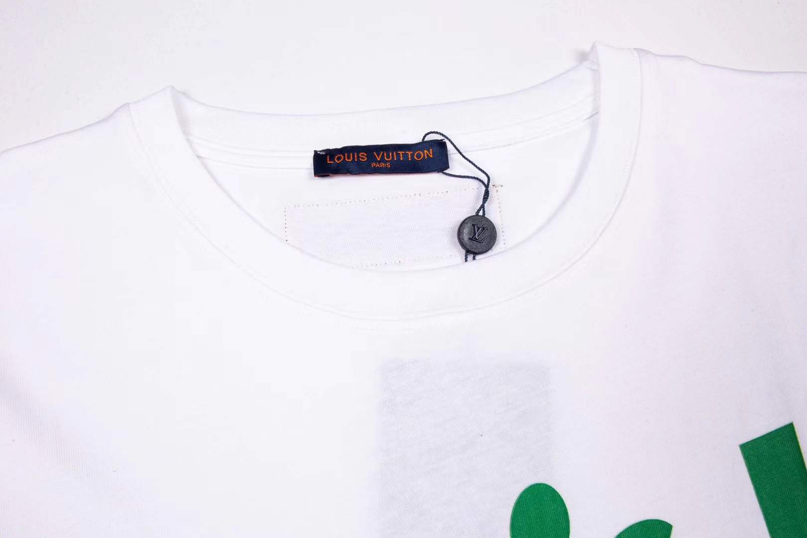 LV bear-graphic white crew neck T-shirt featuring a cartoon teddy bear wearing sunglasses and a checkerboard pattern outfit, prominently branded with "Louis Vuitton" text