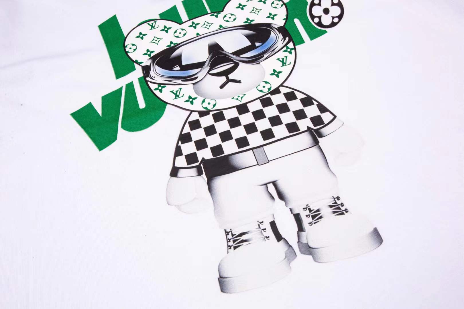 LV bear-graphic white crew neck T-shirt featuring a cartoon teddy bear wearing sunglasses and a checkerboard pattern outfit, prominently branded with "Louis Vuitton" text