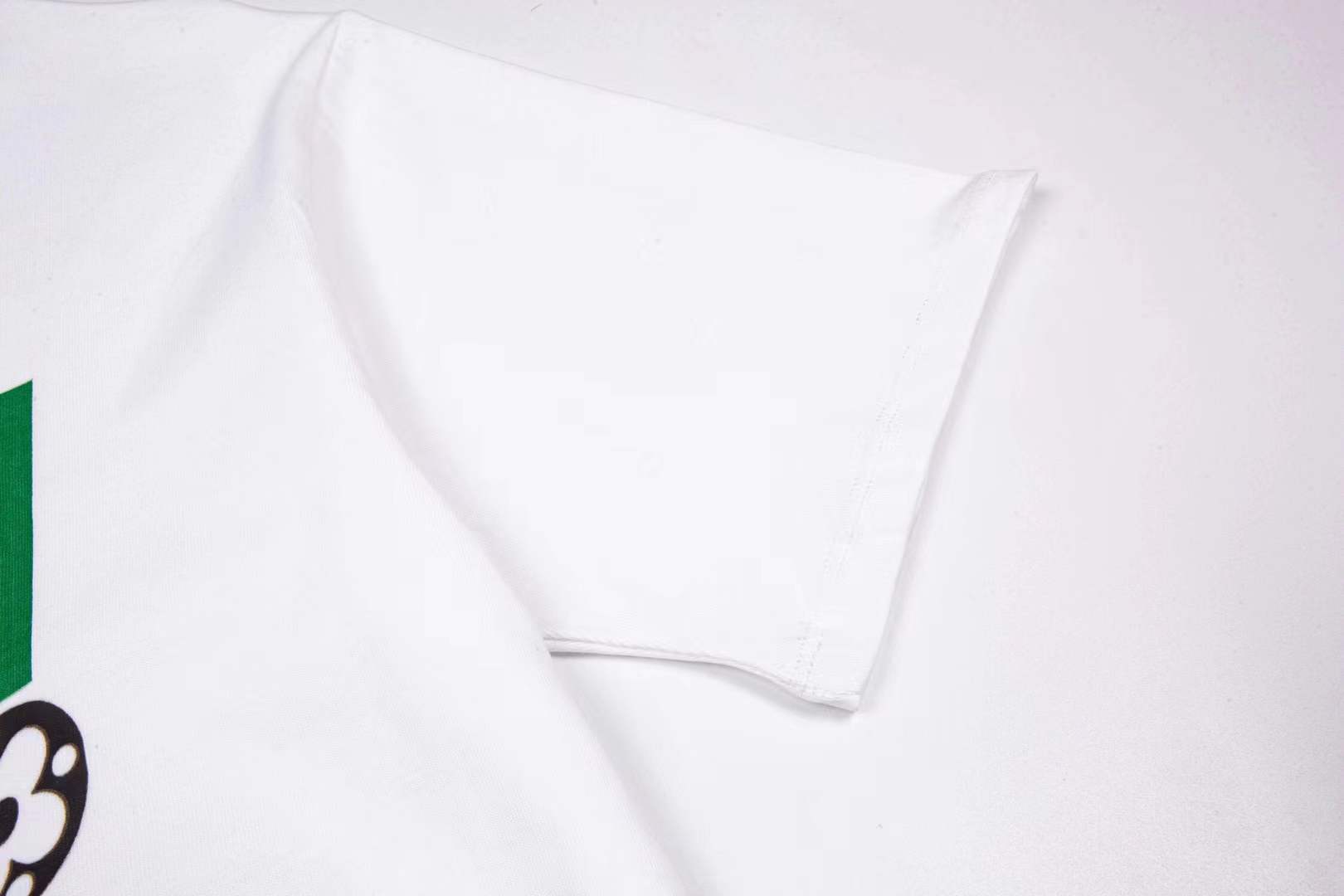 LV bear-graphic white crew neck T-shirt featuring a cartoon teddy bear wearing sunglasses and a checkerboard pattern outfit, prominently branded with "Louis Vuitton" text