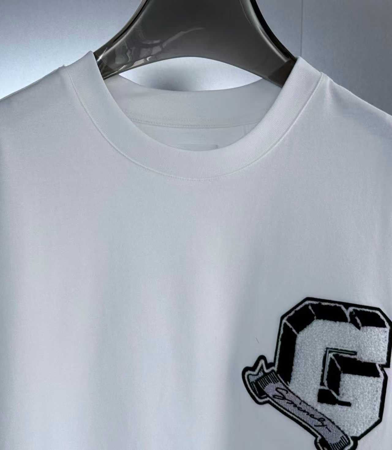 Givenchy white College Tee featuring an embroidered black and white stylized letter "G" logo patch on the chest.
