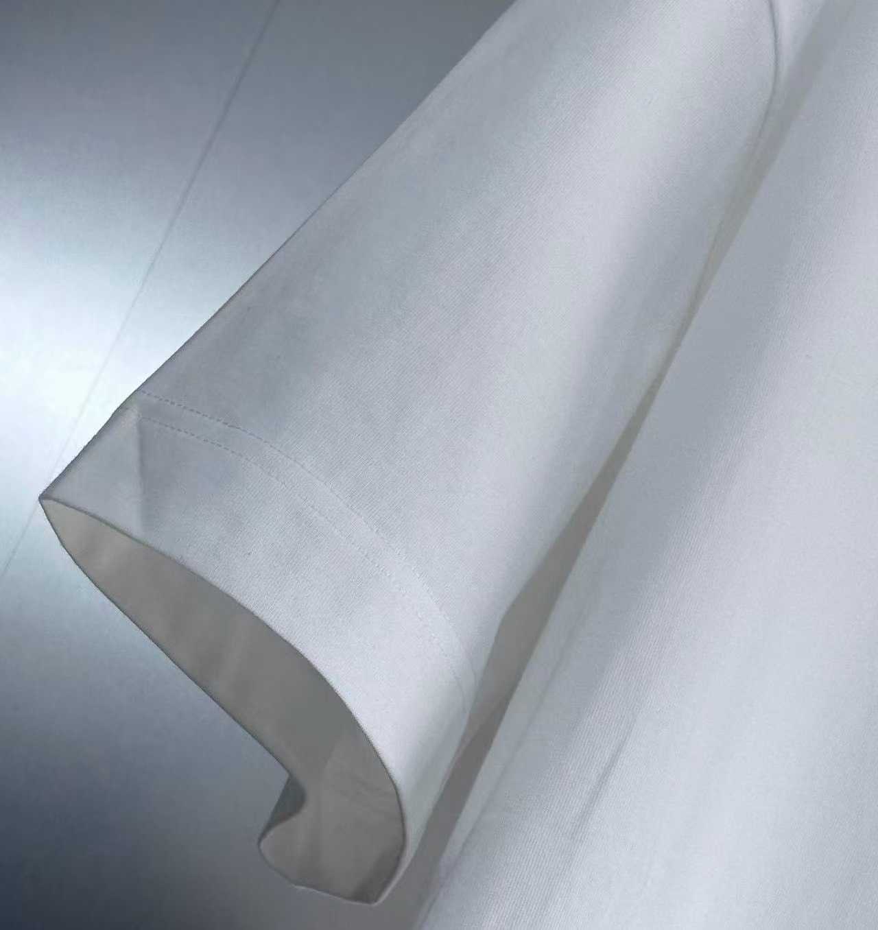 Givenchy white College Tee featuring an embroidered black and white stylized letter "G" logo patch on the chest.