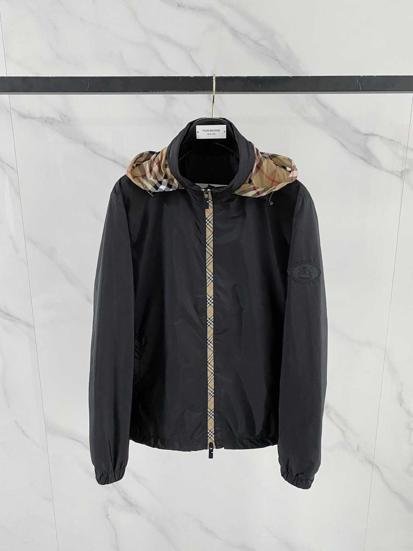 Burberry black check motif hooded jacket, which is a lightweight, reversible nylon jacket featuring the brand's iconic house check pattern