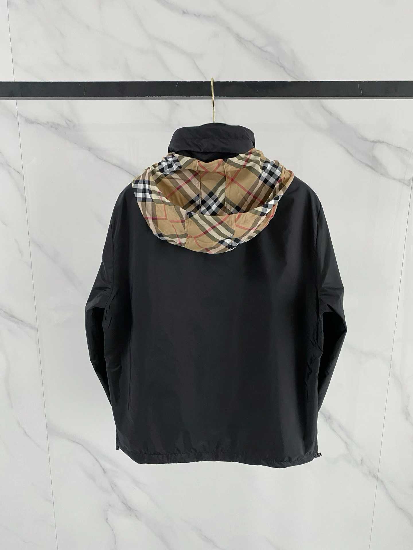 Burberry black check motif hooded jacket, which is a lightweight, reversible nylon jacket featuring the brand's iconic house check pattern