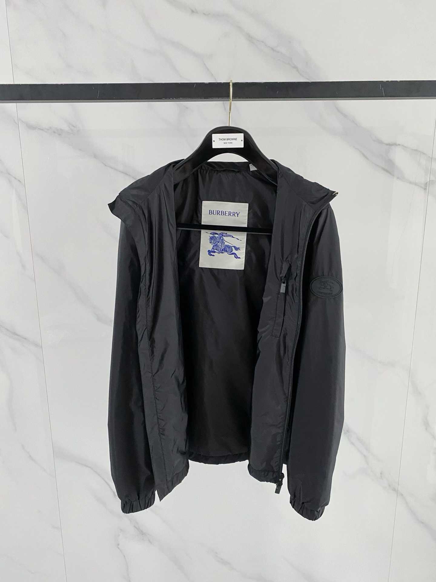 Burberry black check motif hooded jacket, which is a lightweight, reversible nylon jacket featuring the brand's iconic house check pattern