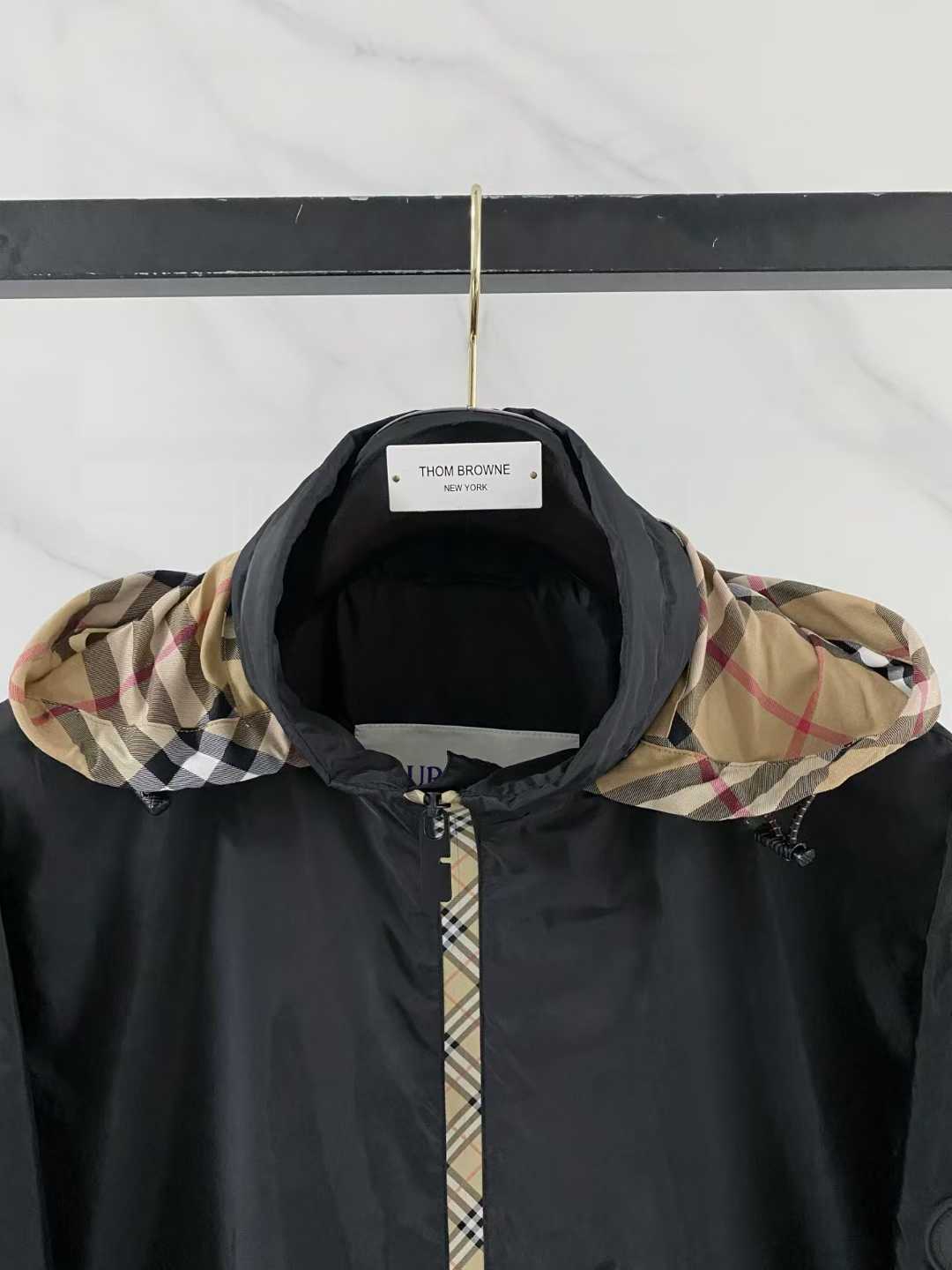 Burberry black check motif hooded jacket, which is a lightweight, reversible nylon jacket featuring the brand's iconic house check pattern