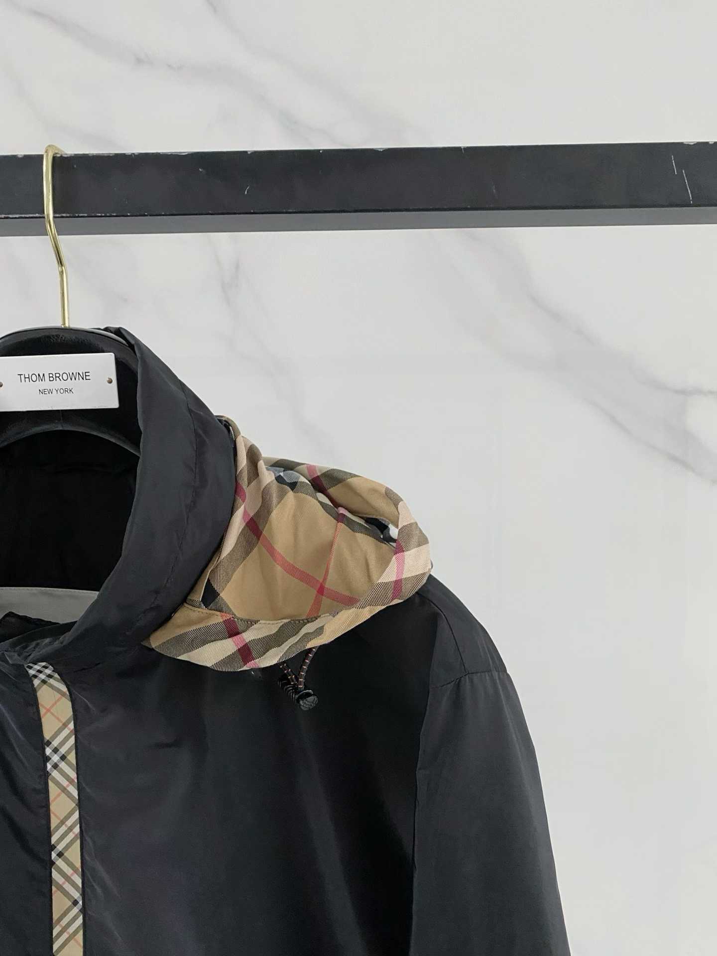 Burberry black check motif hooded jacket, which is a lightweight, reversible nylon jacket featuring the brand's iconic house check pattern