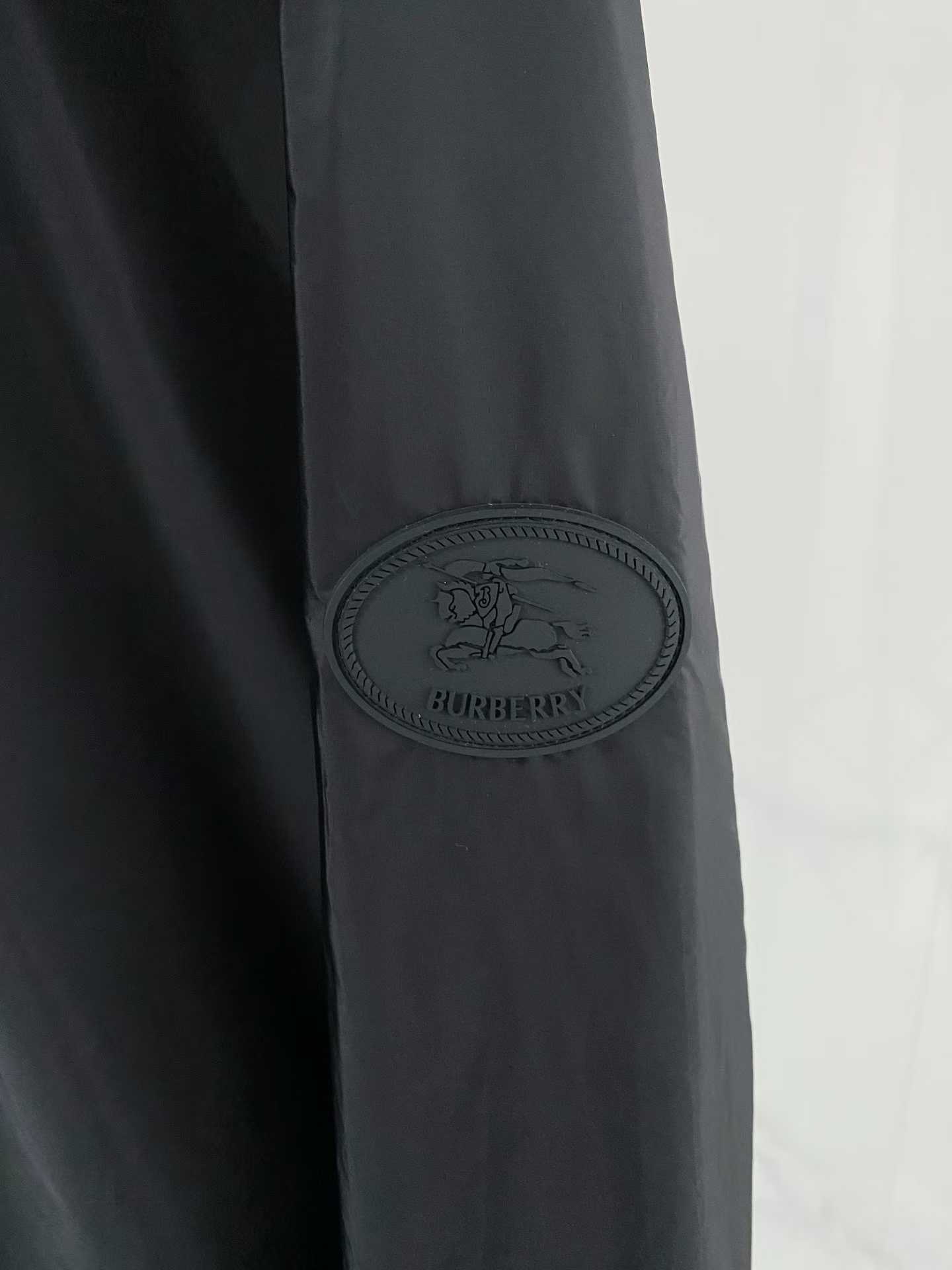 Burberry black check motif hooded jacket, which is a lightweight, reversible nylon jacket featuring the brand's iconic house check pattern