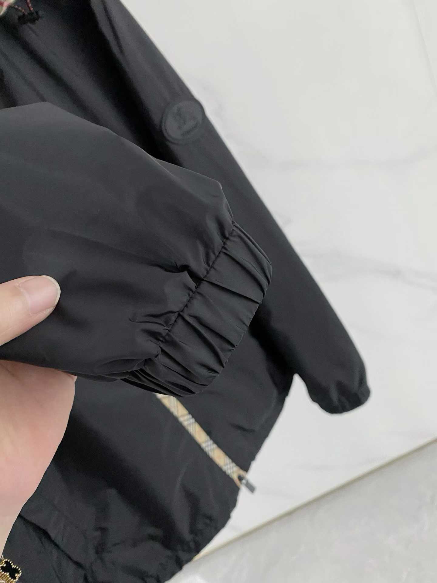 Burberry black check motif hooded jacket, which is a lightweight, reversible nylon jacket featuring the brand's iconic house check pattern