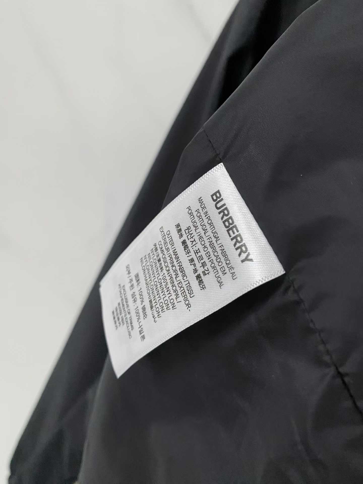 Burberry black check motif hooded jacket, which is a lightweight, reversible nylon jacket featuring the brand's iconic house check pattern