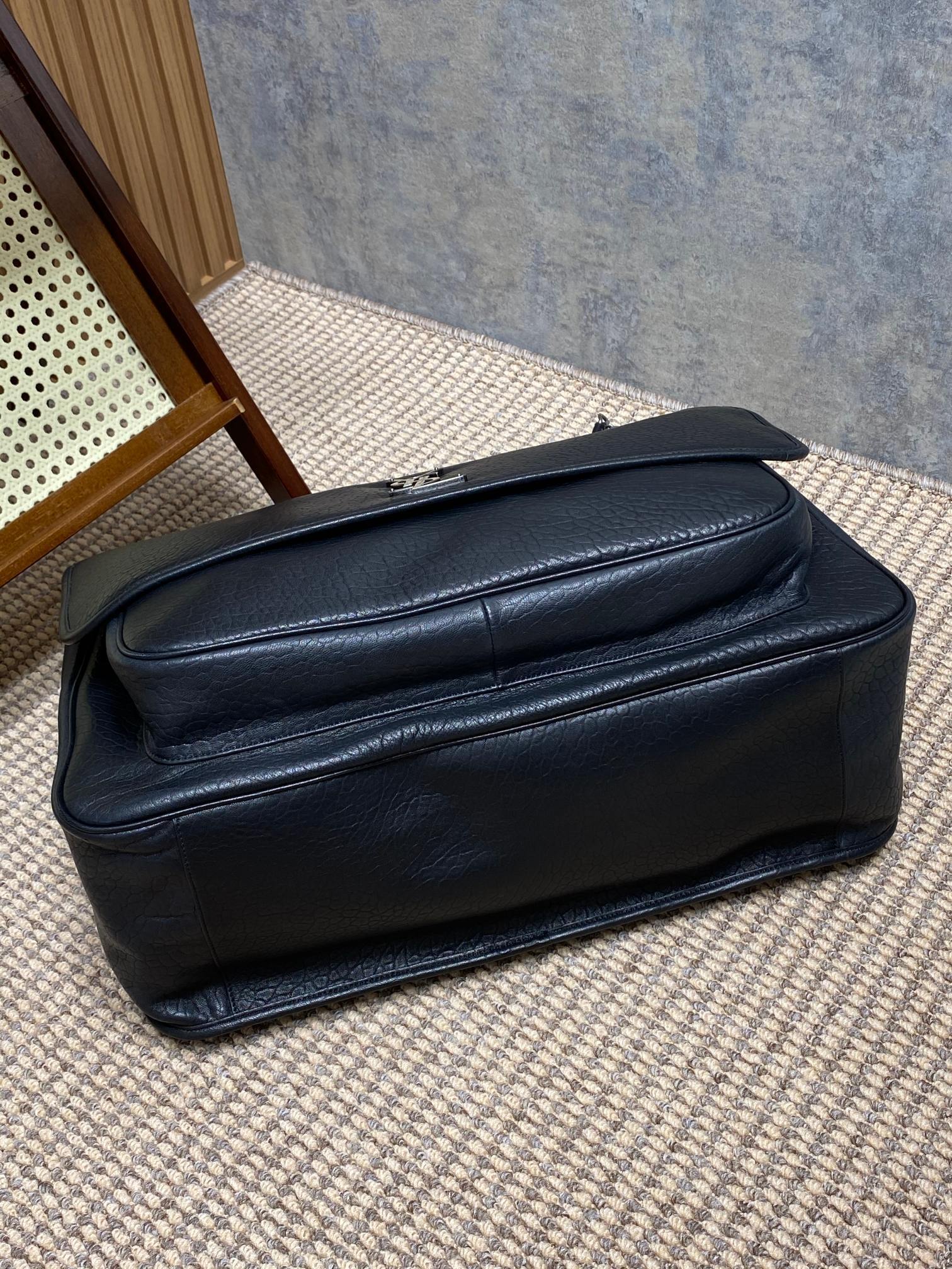 Saint Laurent Niki shoulder bag recognized by its crinkled leather, YSL emblem, and chain strap.