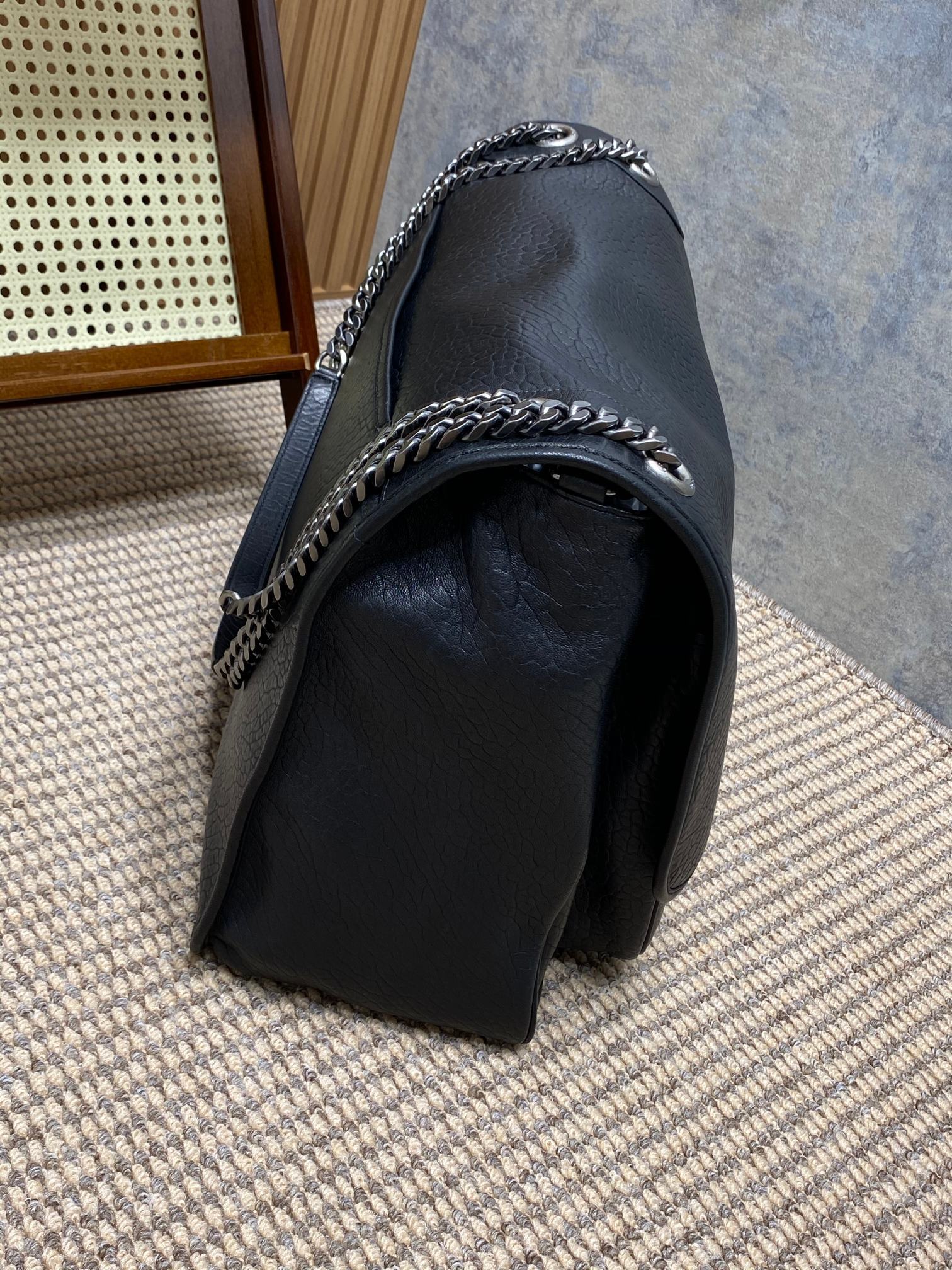 Saint Laurent Niki shoulder bag recognized by its crinkled leather, YSL emblem, and chain strap.