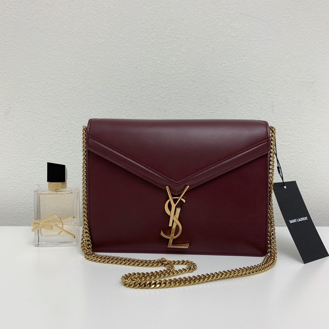 Saint Laurent Cassandra Medium Chain Bag in burgundy leather, featuring an envelope-shaped flap with a gold-tone metal YSL logo clasp