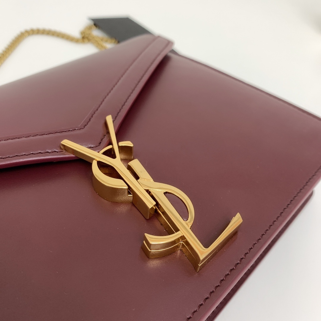 Saint Laurent Cassandra Medium Chain Bag in burgundy leather, featuring an envelope-shaped flap with a gold-tone metal YSL logo clasp