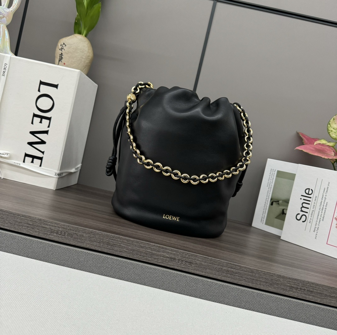 Loewe Flamenco Purse Bucket bag crafted from black nappa lambskin leather and featuring a signature gold chain strap