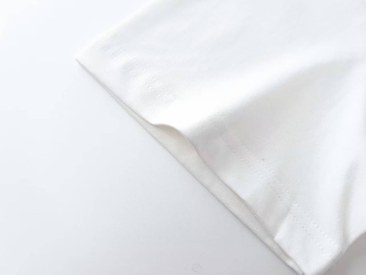 Burberry Label Appliqué Cotton Oversized T-Shirt is a white cotton t-shirt featuring a distinctive woven patch inspired by signature trench coat labels.