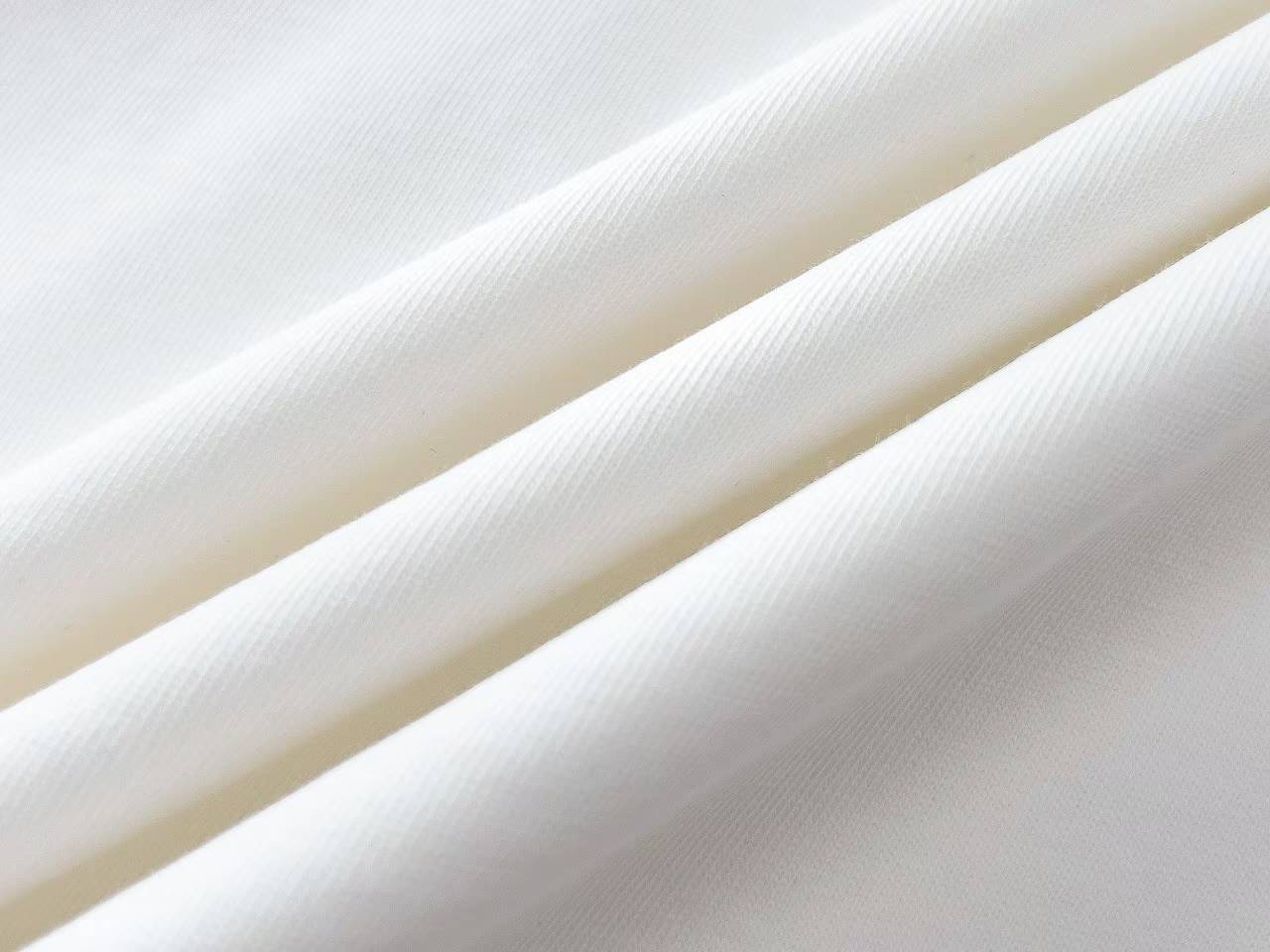 Burberry Label Appliqué Cotton Oversized T-Shirt is a white cotton t-shirt featuring a distinctive woven patch inspired by signature trench coat labels.