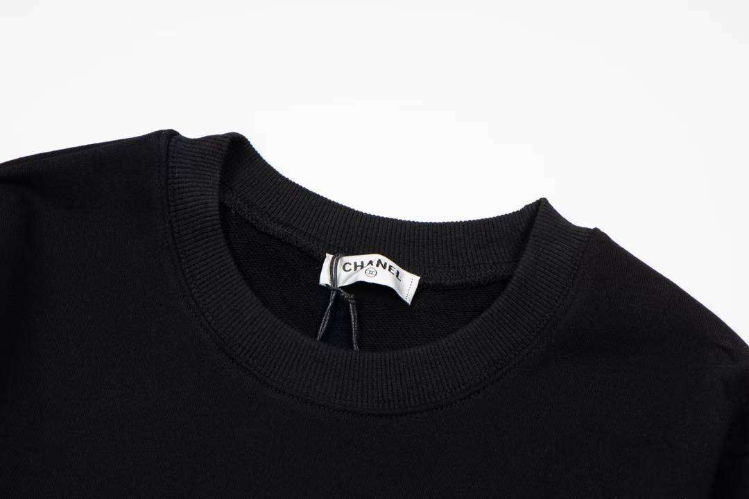 Chanel sweatshirt featuring a prominent white circular logo