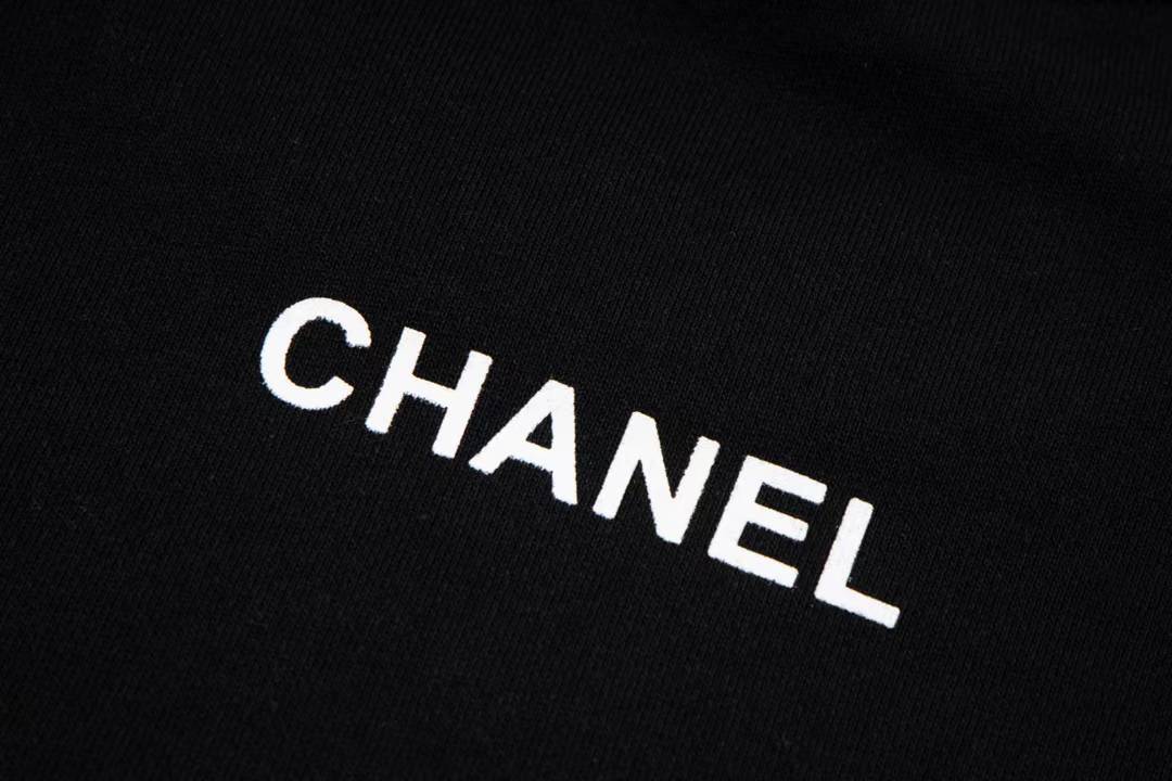 Chanel sweatshirt featuring a prominent white circular logo
