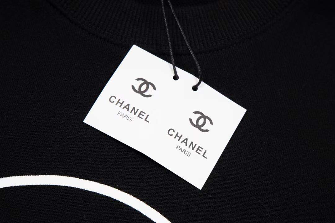 Chanel sweatshirt featuring a prominent white circular logo