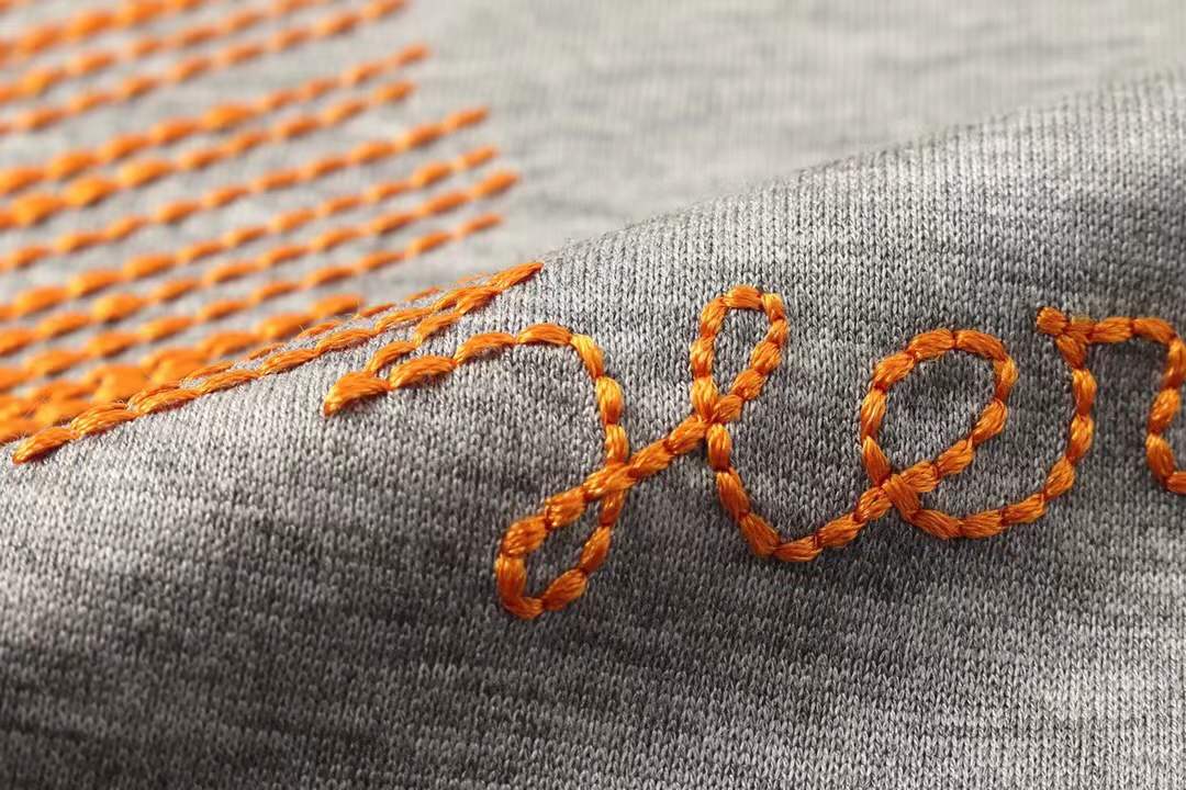 Hermes gray crew neck t-shirt featuring a stylized orange horse logo on the chest