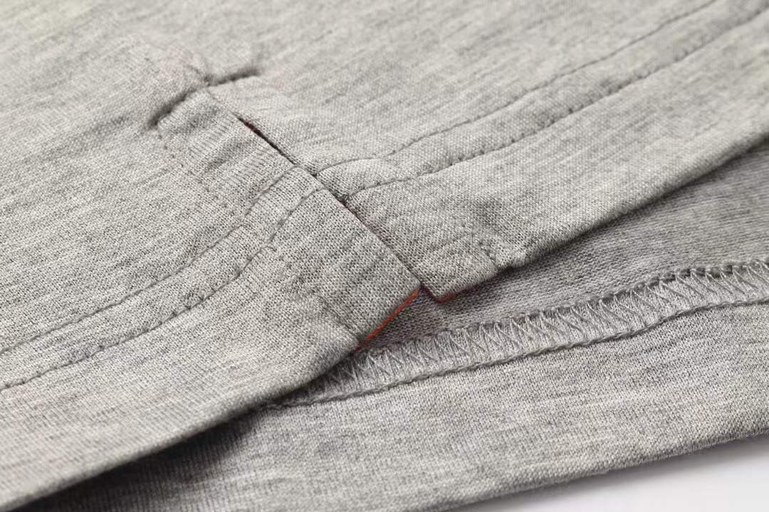 Hermes gray crew neck t-shirt featuring a stylized orange horse logo on the chest