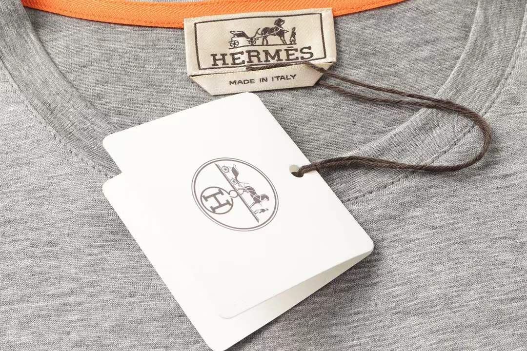 Hermes gray crew neck t-shirt featuring a stylized orange horse logo on the chest