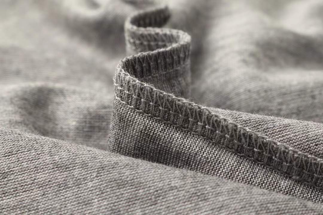 Hermes gray crew neck t-shirt featuring a stylized orange horse logo on the chest