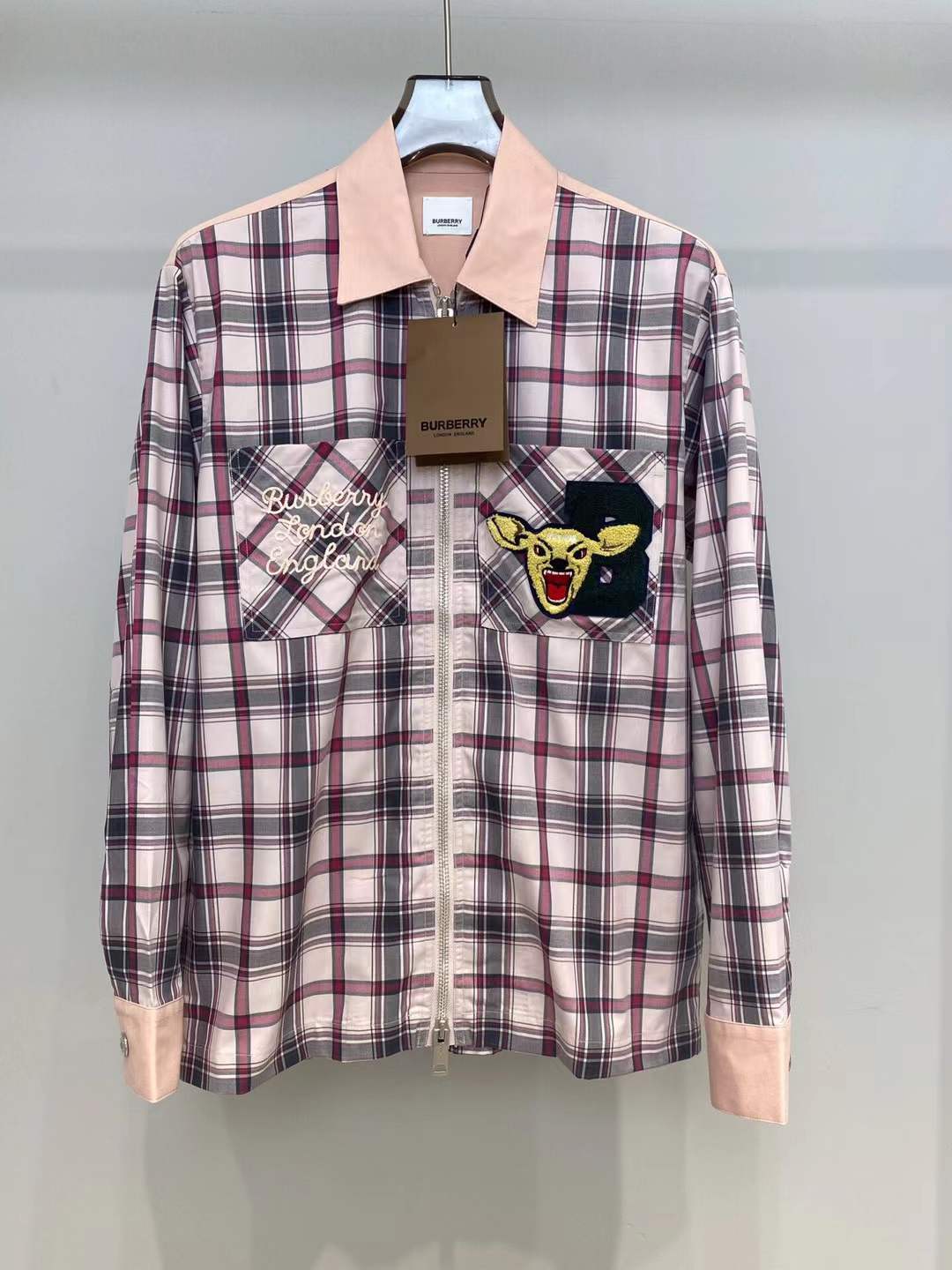 Burberry graphic check varsity overshirt featuring embroidered patches and a zippered front
