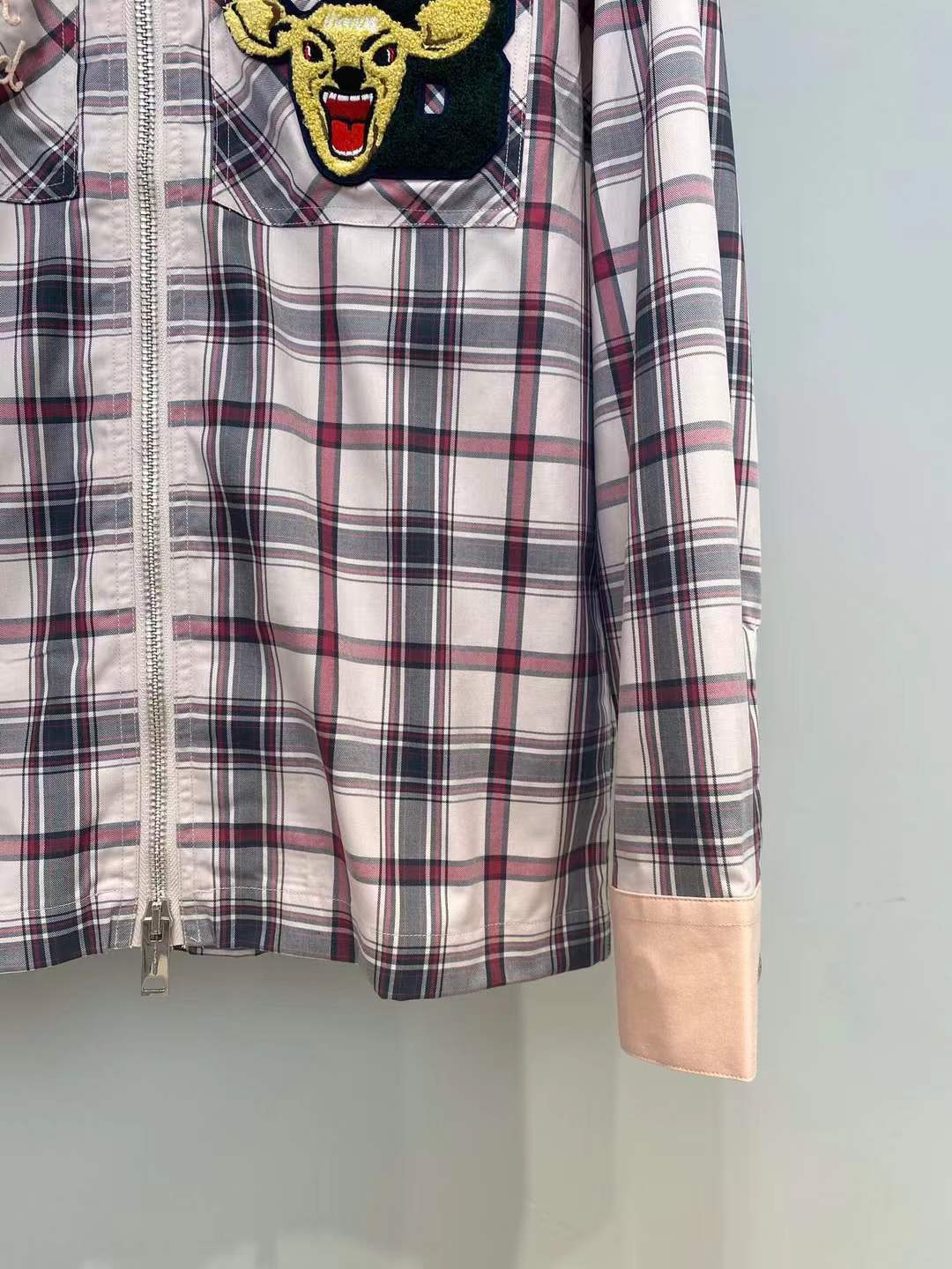 Burberry graphic check varsity overshirt featuring embroidered patches and a zippered front