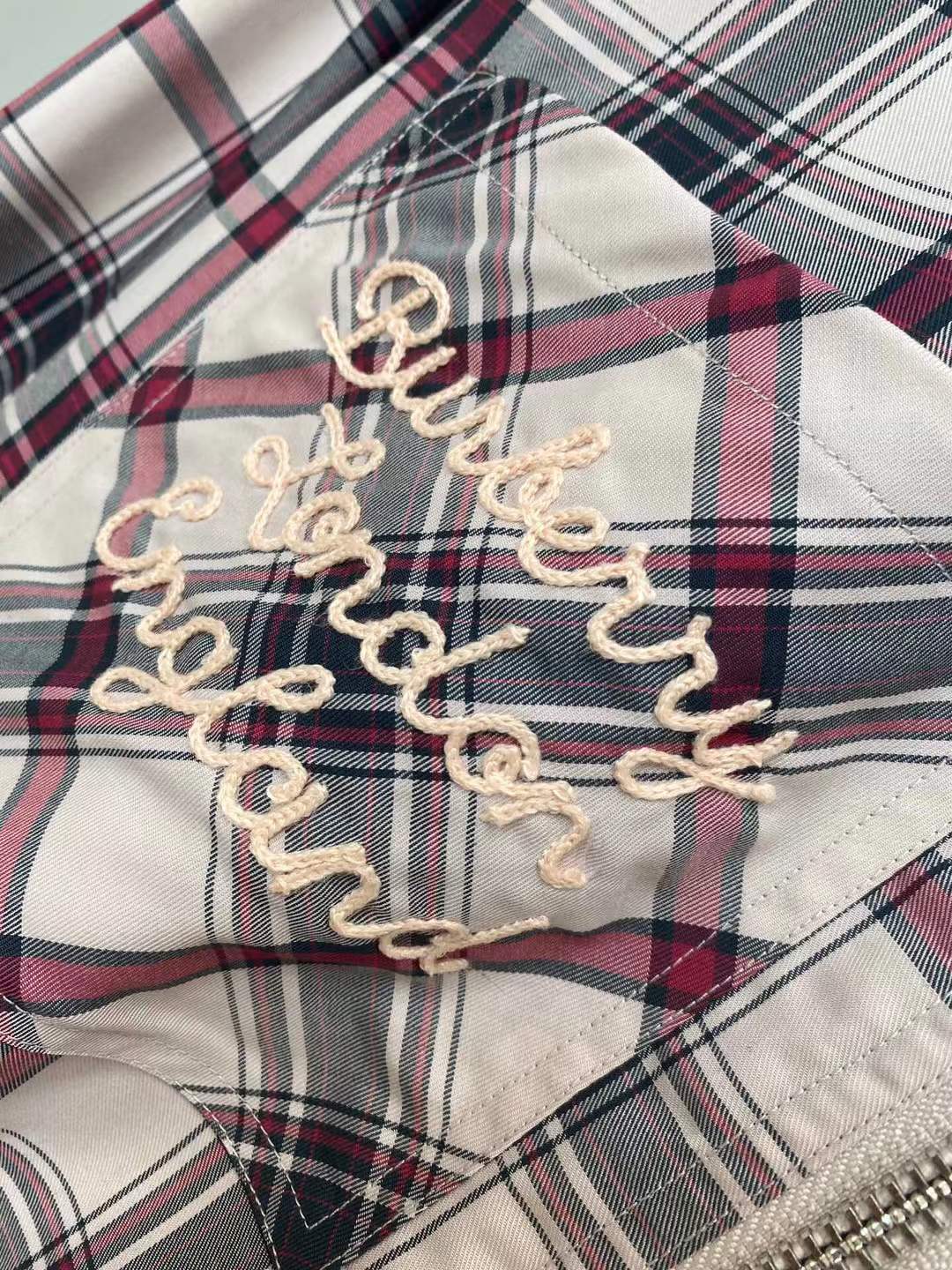 Burberry graphic check varsity overshirt featuring embroidered patches and a zippered front