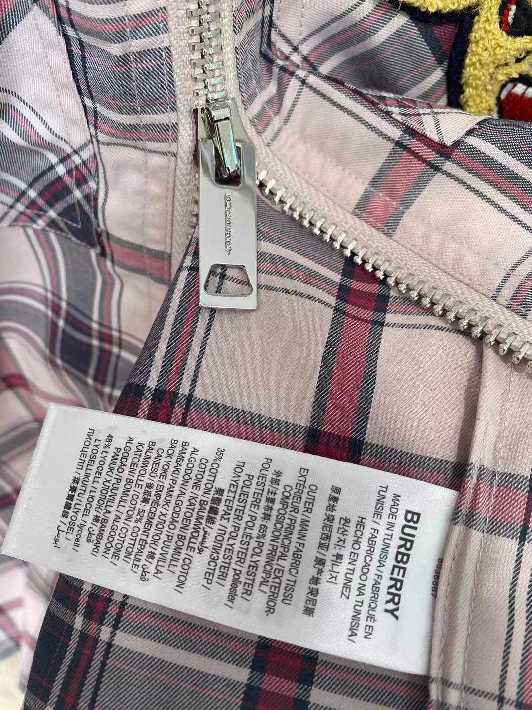 Burberry graphic check varsity overshirt featuring embroidered patches and a zippered front